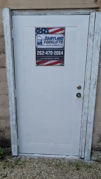 Dairyland Forklifts sign on the shop's white entrance door