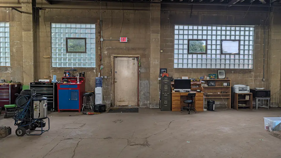 Workbenches and tool cabinets along the back wall of the workshop